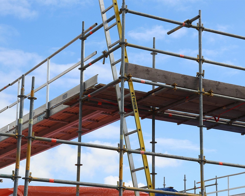 Scaffolders working at height on a construction site