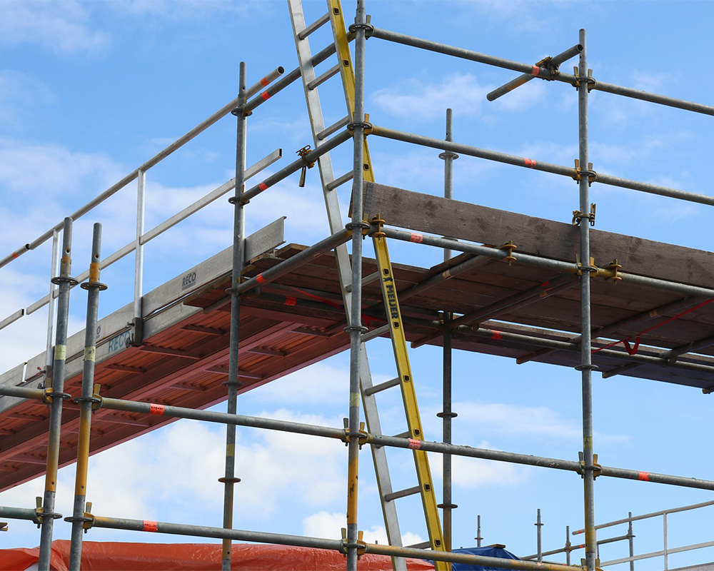 Scaffolders working at height on a construction site