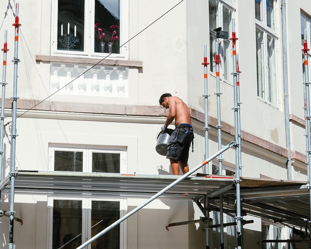Scaffolding erected on a residential street with public access below