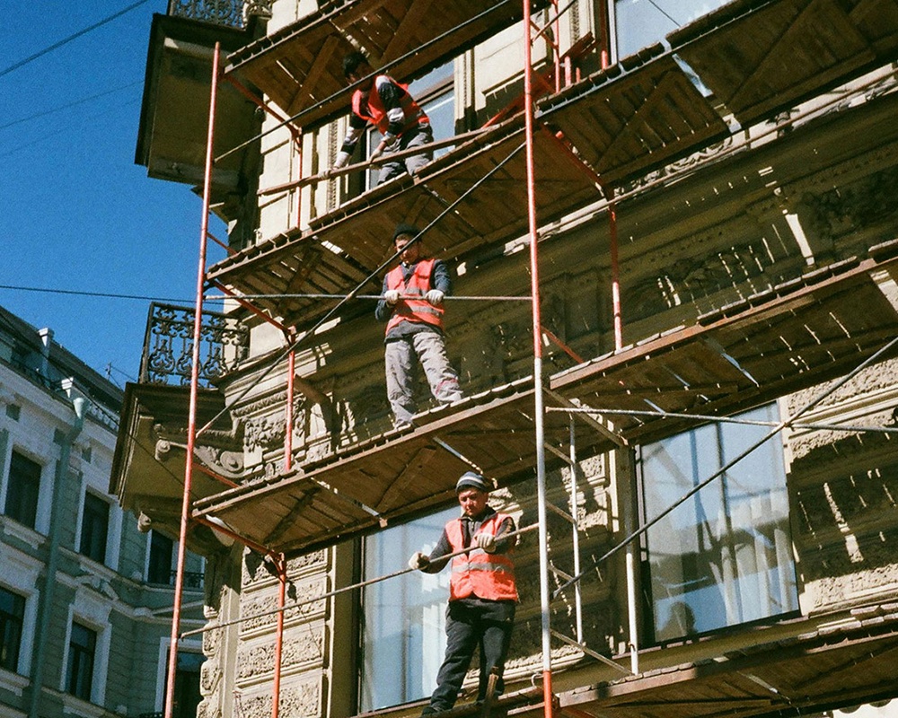 Scaffolders working at height on a construction site
